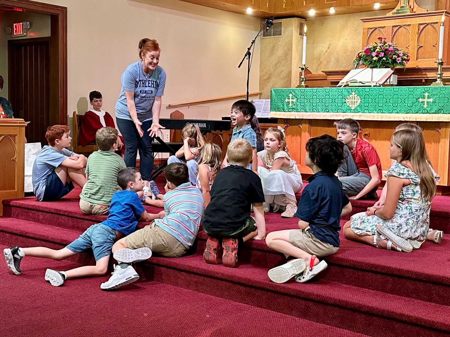 Miss Margaret leads the children during a Children's Chat.
